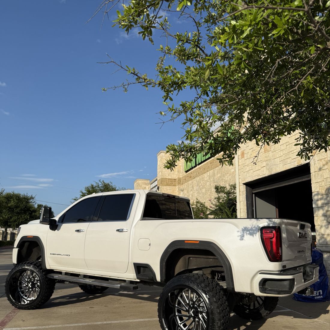 Rear three-quarter view of a lifted GMC Denali HD built in Mansfield, TX